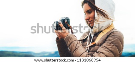 photographer traveler on green top on mountain, tourist look enjoy nature panoramic landscape in trip, girl holding in hands digital photo camera, hiker taking click photography, holiday hobby concept