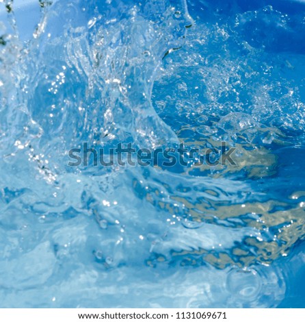 
splashing water on a blue background, motion of water