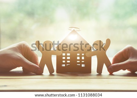 Hands holding little wooden men and house. Symbol of construction, family, sweet home concept Royalty-Free Stock Photo #1131088034