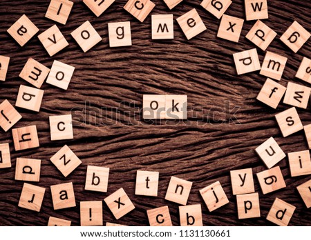 OK word written cube on wooden background. Vintage concept.
