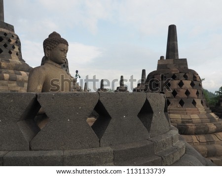 Meditating Buddha Statue at Ancient Borobudur Mahayana Buddhist Temple, Indonesia