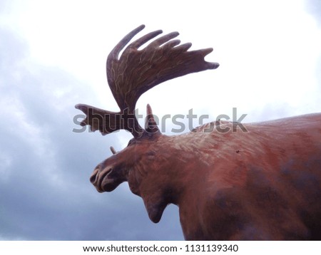 picture of giant large fiberglass moose facing cloudy sky symbol of the Northwood Canada travel 