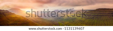 Panorama Of Beautiful Mountain Scene And Sunset In Faroe Islands, Sunrise Over Mountain In Faroe Islands Royalty-Free Stock Photo #1131139607