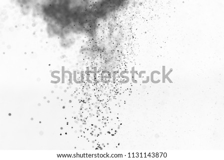 Black particles of charcoal splash on white background, air pollution