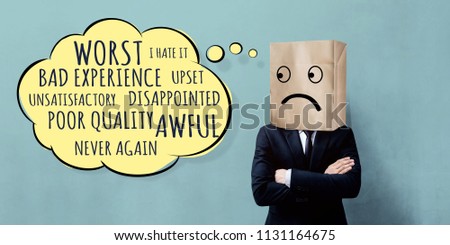 Customer Experience Concept. Unhappy Businessman Client with Sadness Emotion Face on Paper Bag, Crossed arms and looking at Wording of Negative Reviews on Think Bubble