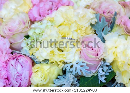 Wedding or Engagement Ring and Beautiful Bouquet of Flowers