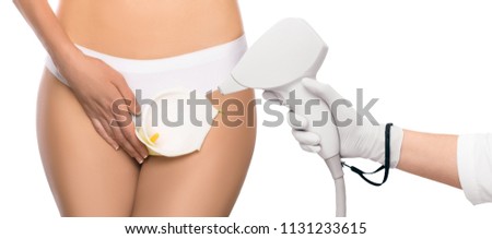 concept bikini laser epilation , woman holding flower on a background of white panties, close-up, depilation of a bikini zone