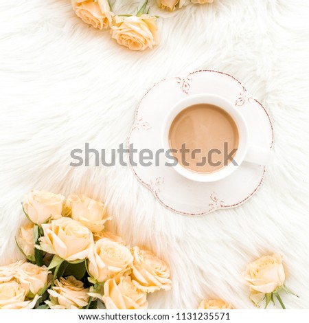 Composition of pastel tea rose bouquet flowers and a Cup of cocoa on white background. Floral background. Flat lay, top view.  