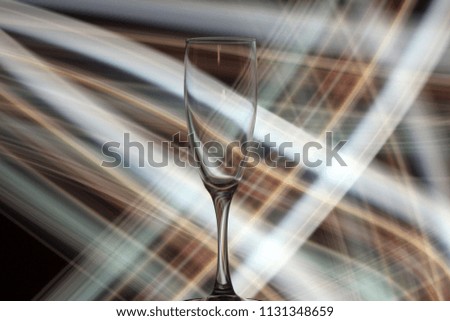 Night photo of champagne glass with bright lights and sparks on the background