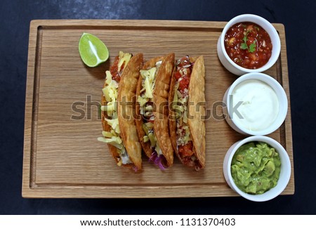 mexican tacos on a wood board