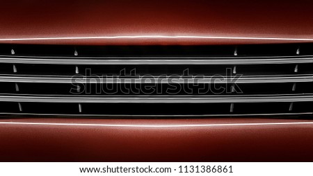 shiny car grill. reflective nose of automobile.