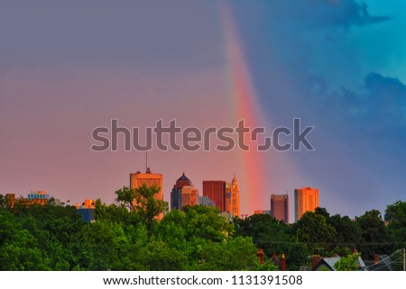 A vibrant rainbow creates a whimsical display with sunset colors in the sky over Columbus, Ohio.