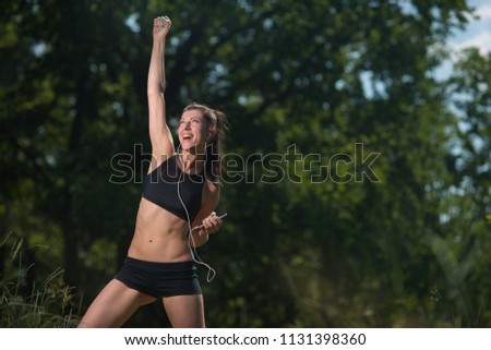 Girl throws up her hand with joy, victory, winnings, success.