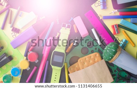 Concept back to school watch chalk line cookies stationery on black background. Top view Flat lay