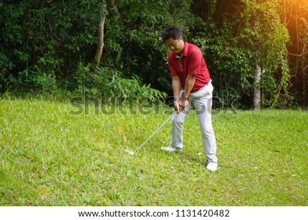 Blurred golfer playing golf in beautiful golf course in the evening golf course with sunshine in thailand