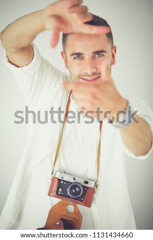 Young man with camera. Isolated over white background