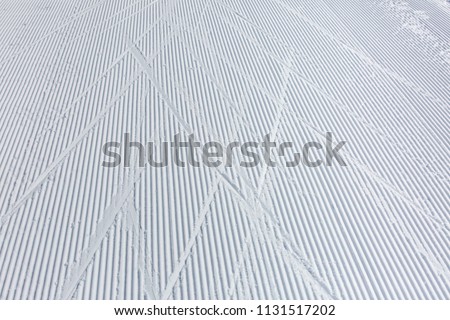 Ski tracks on the snow piste prepared to championat of cross country skiing Royalty-Free Stock Photo #1131517202
