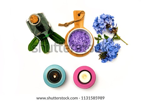 Beautiful spa composition .  Blue flowers and candlelight on a white background