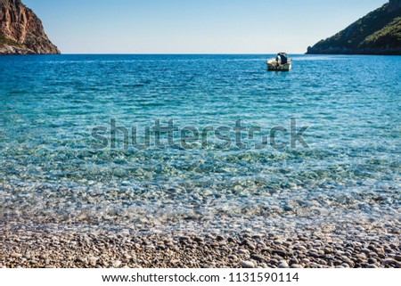 Motor boat anchored in bay, calm blue water. Travel holidays concept.