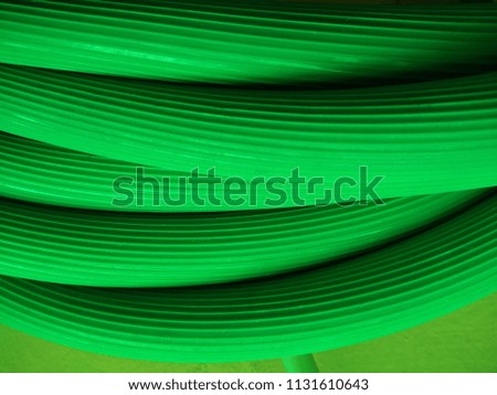 Abstract background of Long Green Water Pipe. Macro. Object. Close up. Abstract background of Green color. Abstract lines. Continuous lines. Plumbing. Irrigation. Industrial. Engineering. Piping. 
