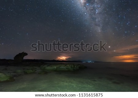 Milky Way galaxy rise above at unknown beach in Kudat, Malaysia. Soft focus and noise due to long expose and high iso.