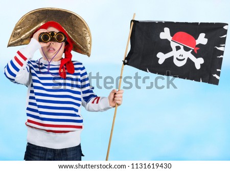 Young boy with with a pirate flag