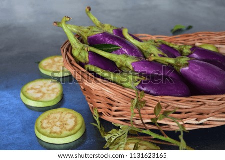 Lavender color Eggplant on wooden net basket royalty free stock images