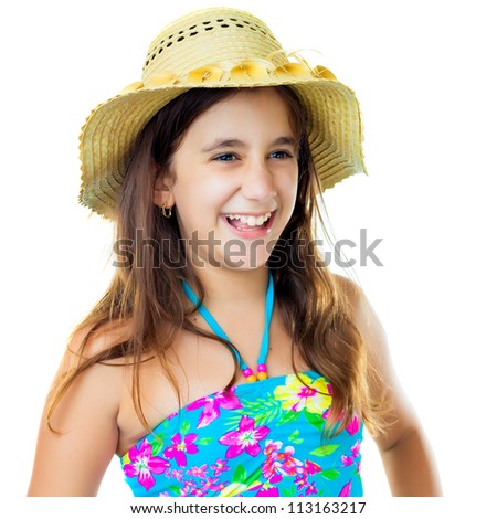 Beautiful hispanic girl wearing a colorful swimsuit and a straw hat laughing isolated on white