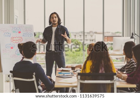 Asian Creative manager man presenting the successful ideas in front of Group Of Asian Business people with casual suit in serious action in the modern workplace, Group people business concept