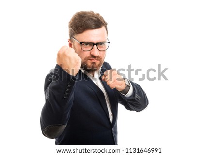 Portrait of angry business man showing both fists gesture isolated on white background with copyspace advertising area