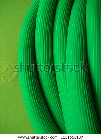 Abstract background of Long Green Water Pipe. Macro. Object. Close up. Abstract background of Green color. Abstract lines. Continuous lines. Plumbing. Irrigation. Industrial. Engineering. Piping. 