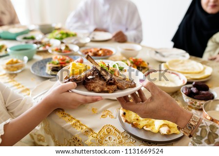 Muslim family having a Ramadan feast Royalty-Free Stock Photo #1131669524