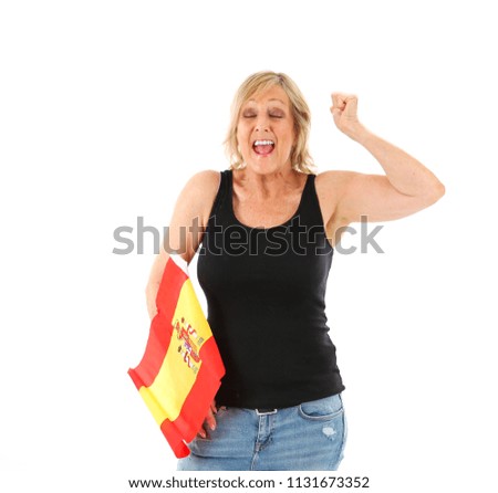 Excited middle aged woman holding a spanish flag against a white background