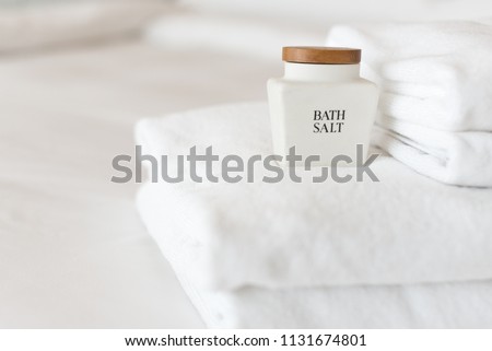 White towels and bottle of bath salt on the bed in a hotel Royalty-Free Stock Photo #1131674801