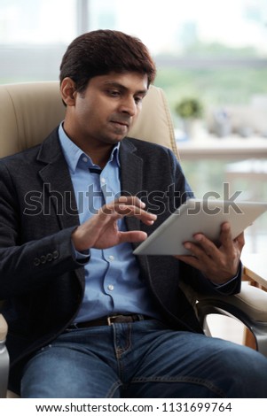 Business executive using application on digital tablet