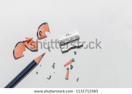 Wooden Pencil, Sharpener And Pencil Shavings Isolated On White Background. Macro Photography