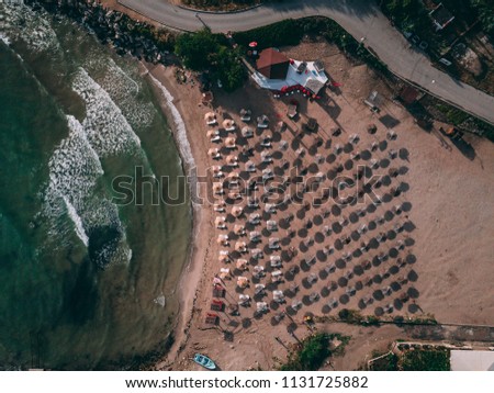 Aerial top view of a small beach with umbrellas near Balchik, Bulgaria