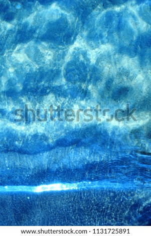 crystalline sea, blue background with reflections in the sea water, abstract moody for summer holidays, vertical