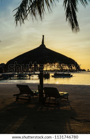 A nice sunset view of a resort in Maldives in the middle of Indian Ocean. Tourists are visiting Maldives more and more nowadays for its paradise environment. 