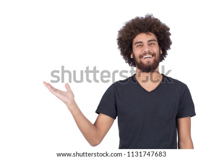 Confident handsome man pointing with one hand inviting or showing something isolated on a white background.