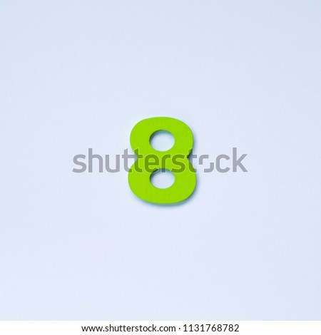 Wooden number 8 with green color on white background.