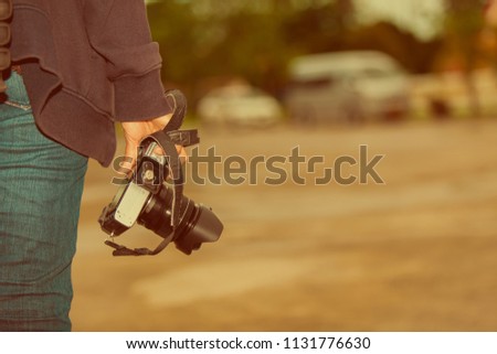Woman holding the camera. prepare to take pictures on vacation.