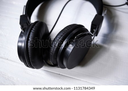 Black headphones on a white table.