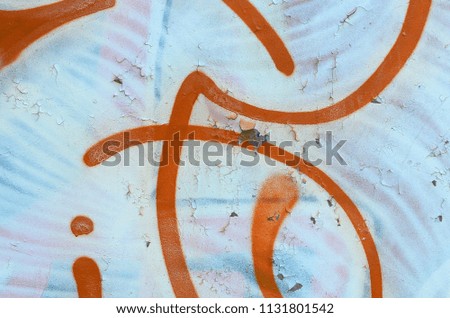 Street art. Abstract background image of a fragment of a colored graffiti painting in white and orange tones