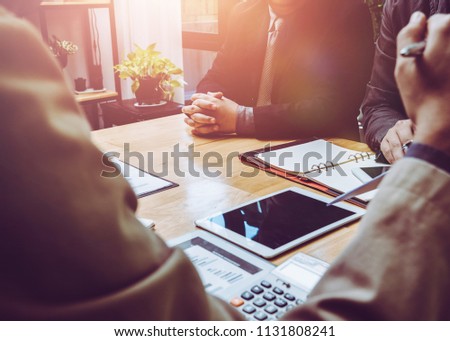 Meeting of tax lawyer business man and company president to discuss the problem of taxation on SMEs, teamwork, working together concept. Royalty-Free Stock Photo #1131808241