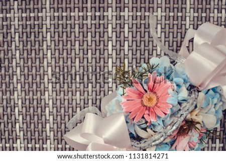 Photo of a framing floral flower bouquet in rustic color on the handwoven mat that can be used for mock ups, backgrounds and card design