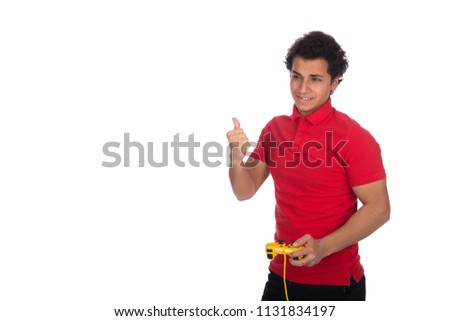 Handsome man holds a joystick, playing video games and he wins, looking very happy, raising thumb up, isolated on white background