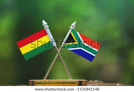 South Africa and Bolivia small flag with blur green background