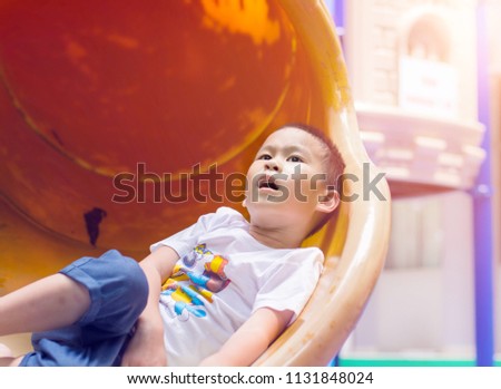 Happy kids playing on slide