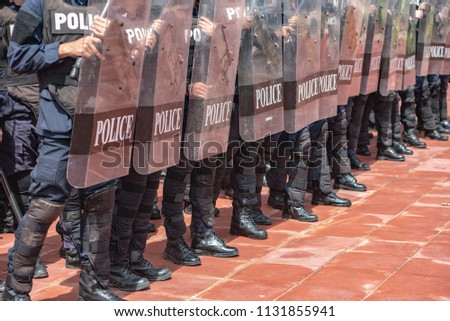Riot police coaches review crowd control